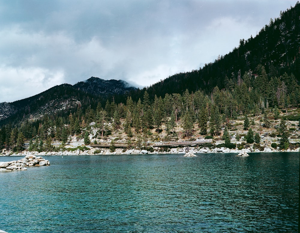 a body of water with a mountain in the background