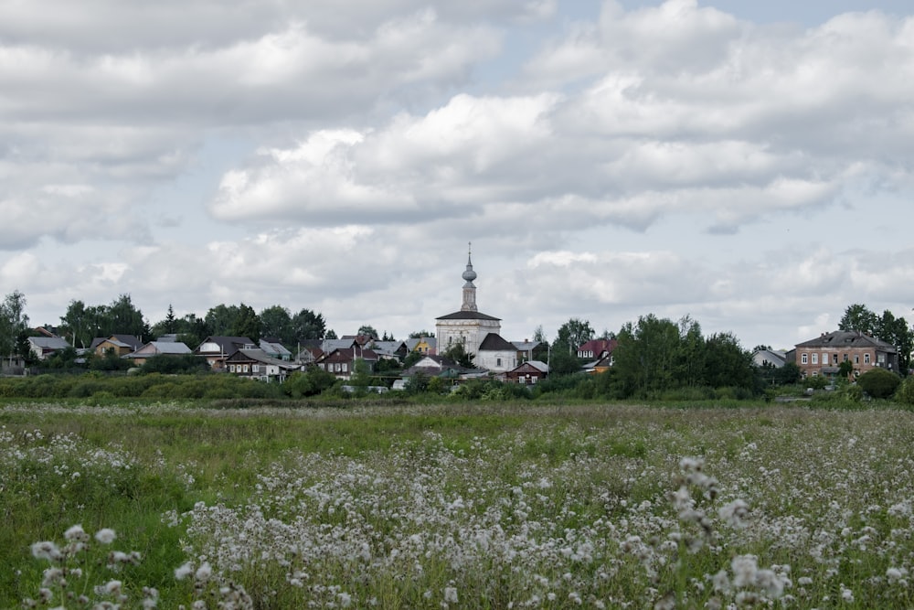 a field with a church in the background