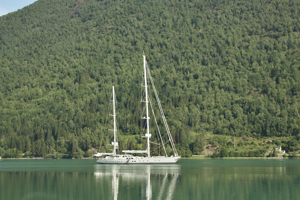 a large white boat floating on top of a lake