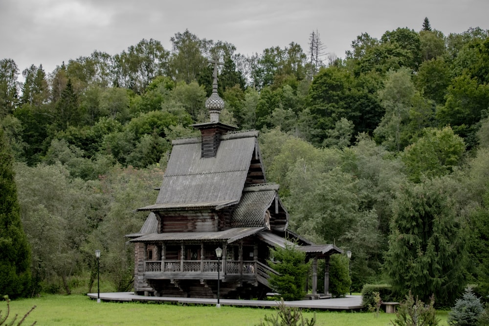 an old wooden house in the middle of a forest