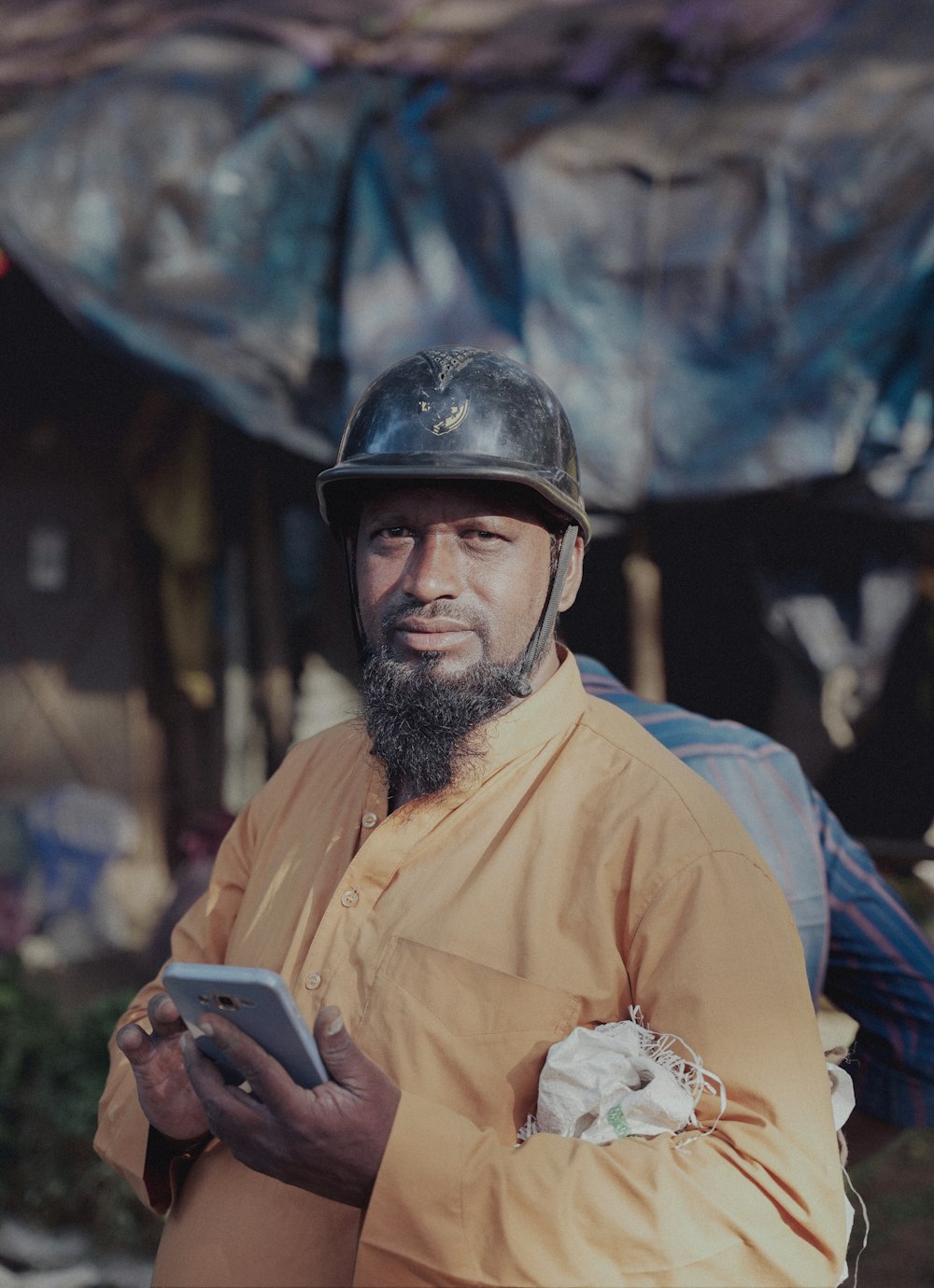 a man wearing a helmet and holding a tablet