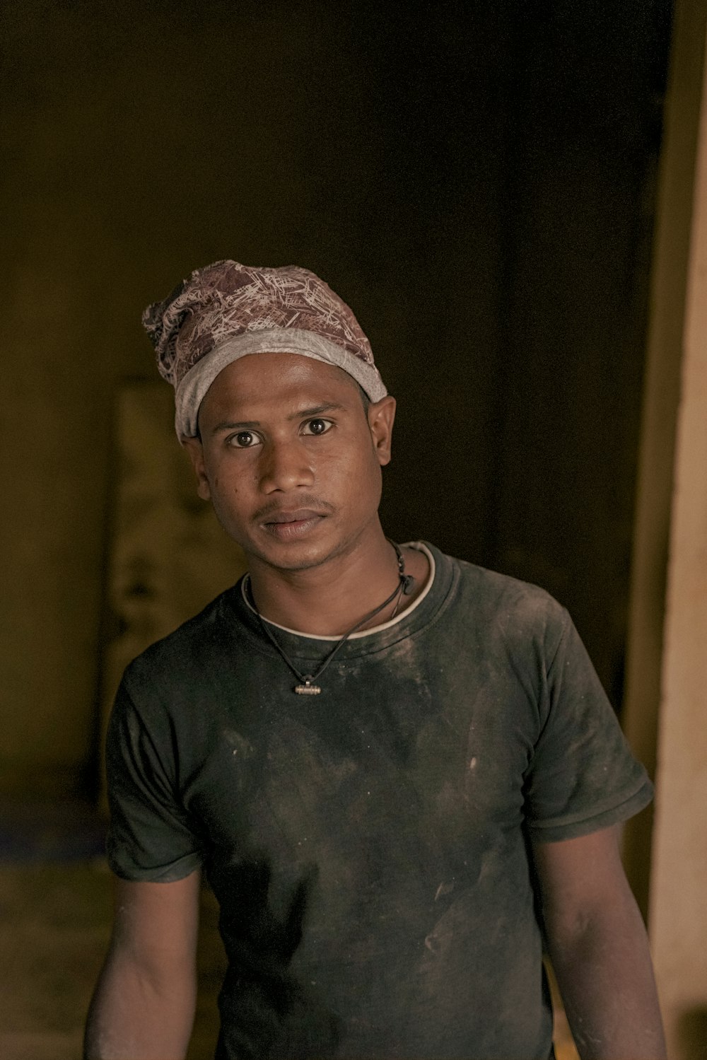 a man with a turban standing in a room