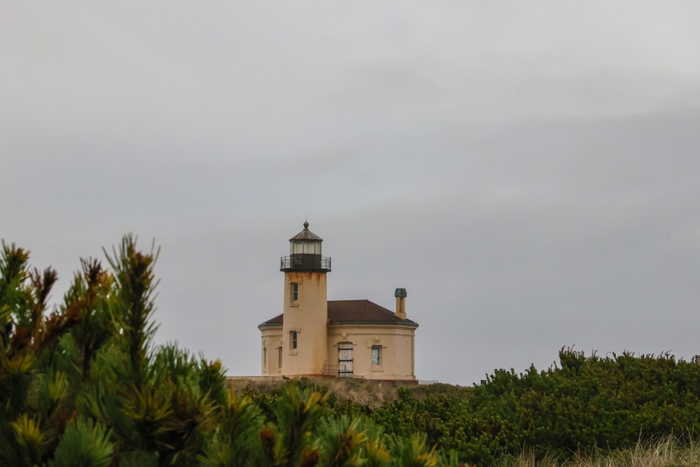 a light house sitting on top of a hill