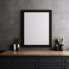 A minimalistic kitchen setting with a wooden countertop. A blank white framed board is hung on a gray tiled wall. On the counter, various kitchen items like vases and cooking utensils are neatly arranged.