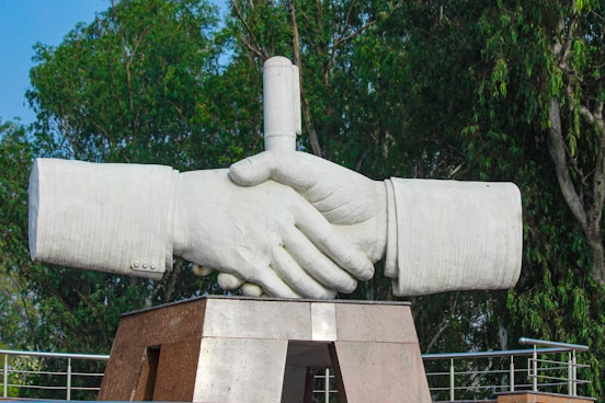 a statue of two hands holding each other