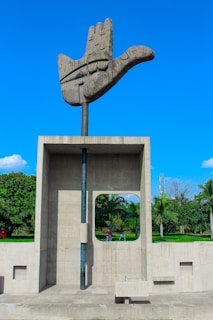 a sculpture of a hand holding a door
