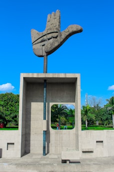 a sculpture of a hand holding a door