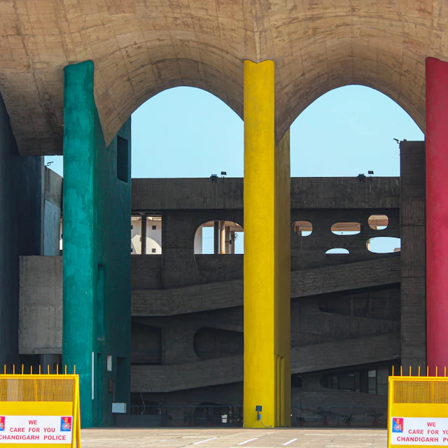 A large building with multiple colored columns in front of it