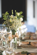 Elegant silver and natural flower bouquet arrangement on a rustic wooden table.