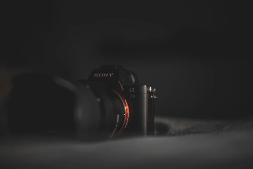 a sony camera sitting on top of a bed