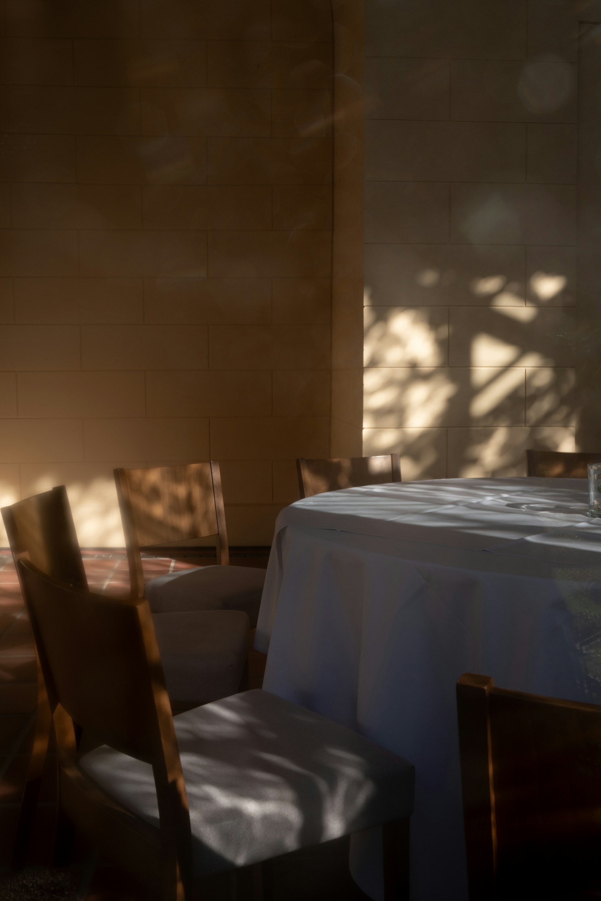 a table with a white table cloth and chairs