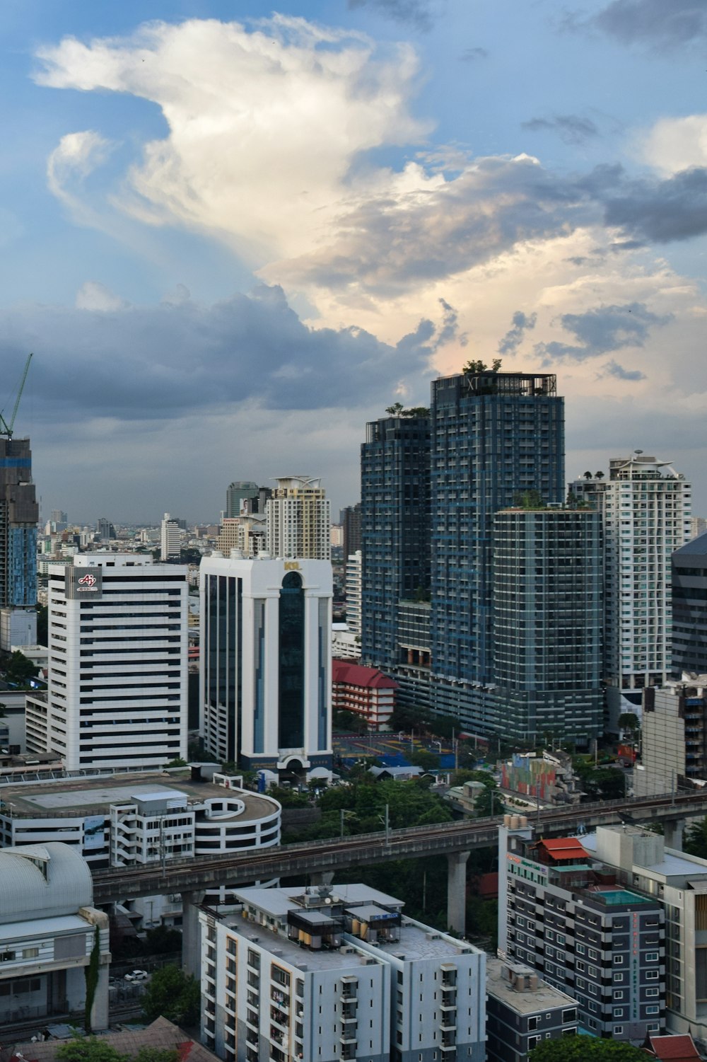 a city with tall buildings and a cloudy sky