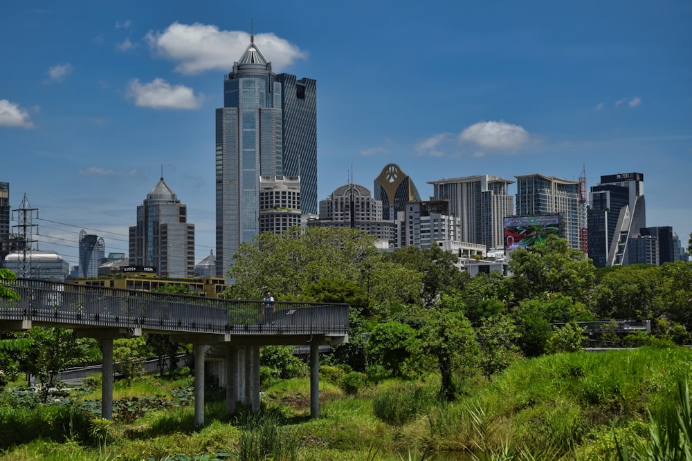 a view of a city skyline with a bridge in the foreground