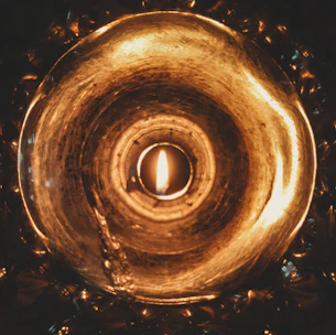 A warm, intimate close-up of a softly glowing flame symbolizing inner transformation and truth.