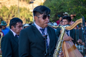 Johnny Mag Sax passionately playing saxophone at a sunset wedding ceremony.