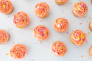 a table topped with lots of cupcakes covered in frosting