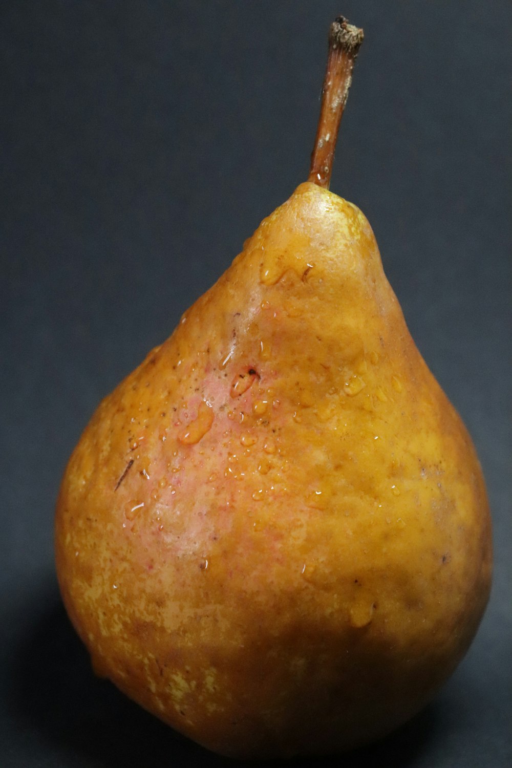 a yellow pear sitting on top of a table