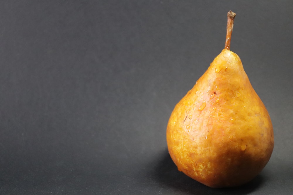 a single pear on a black background