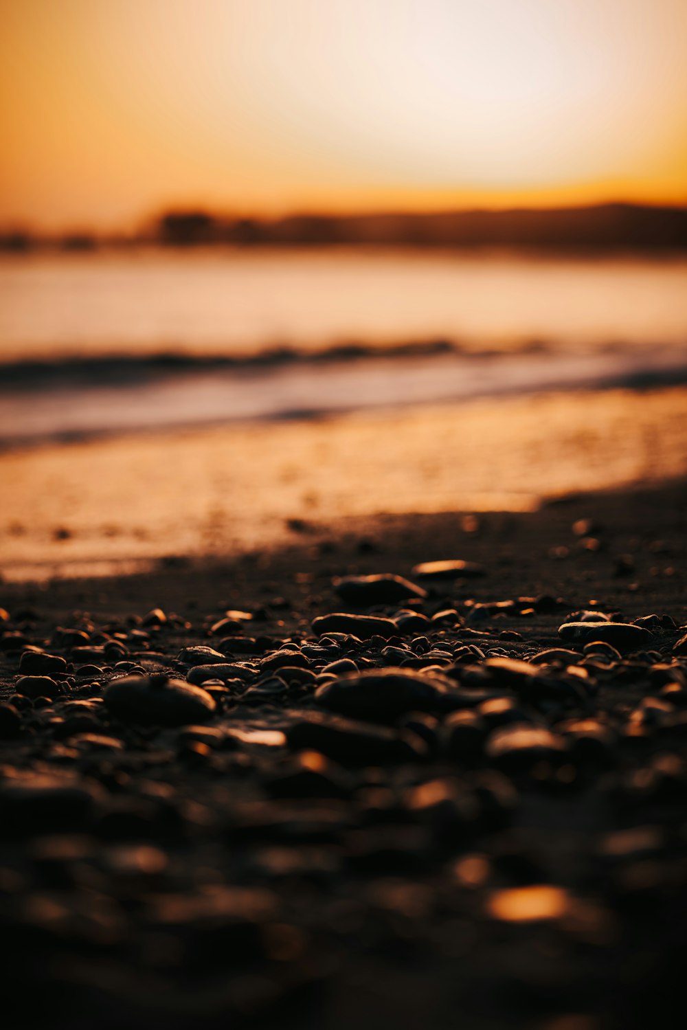 a close up of rocks on a beach near the ocean