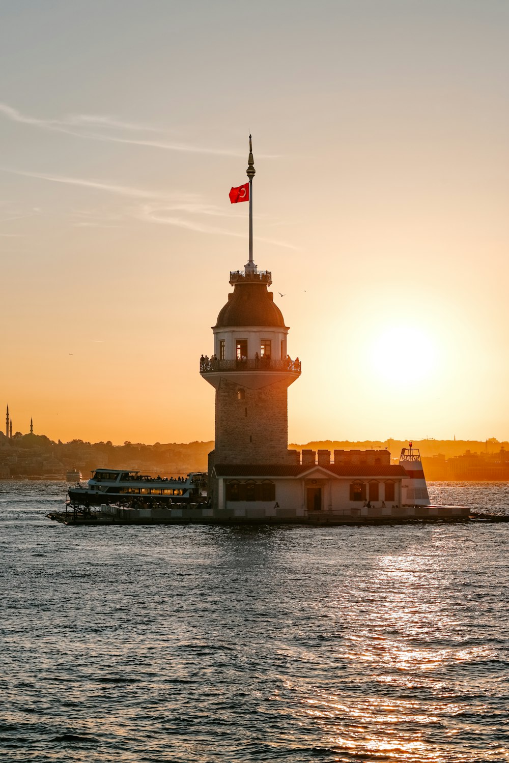 a light house sitting on top of a body of water