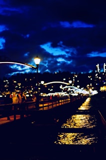 Evening lights of the lively boardwalk with shops and eateries glowing warmly.