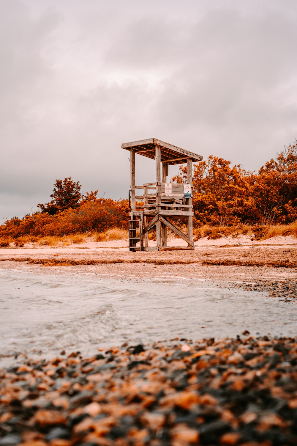 a lifeguard stand on the shore of a lake