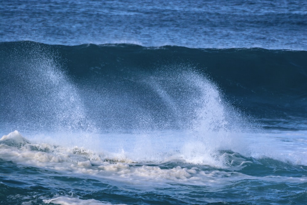 a man riding a wave on top of a surfboard