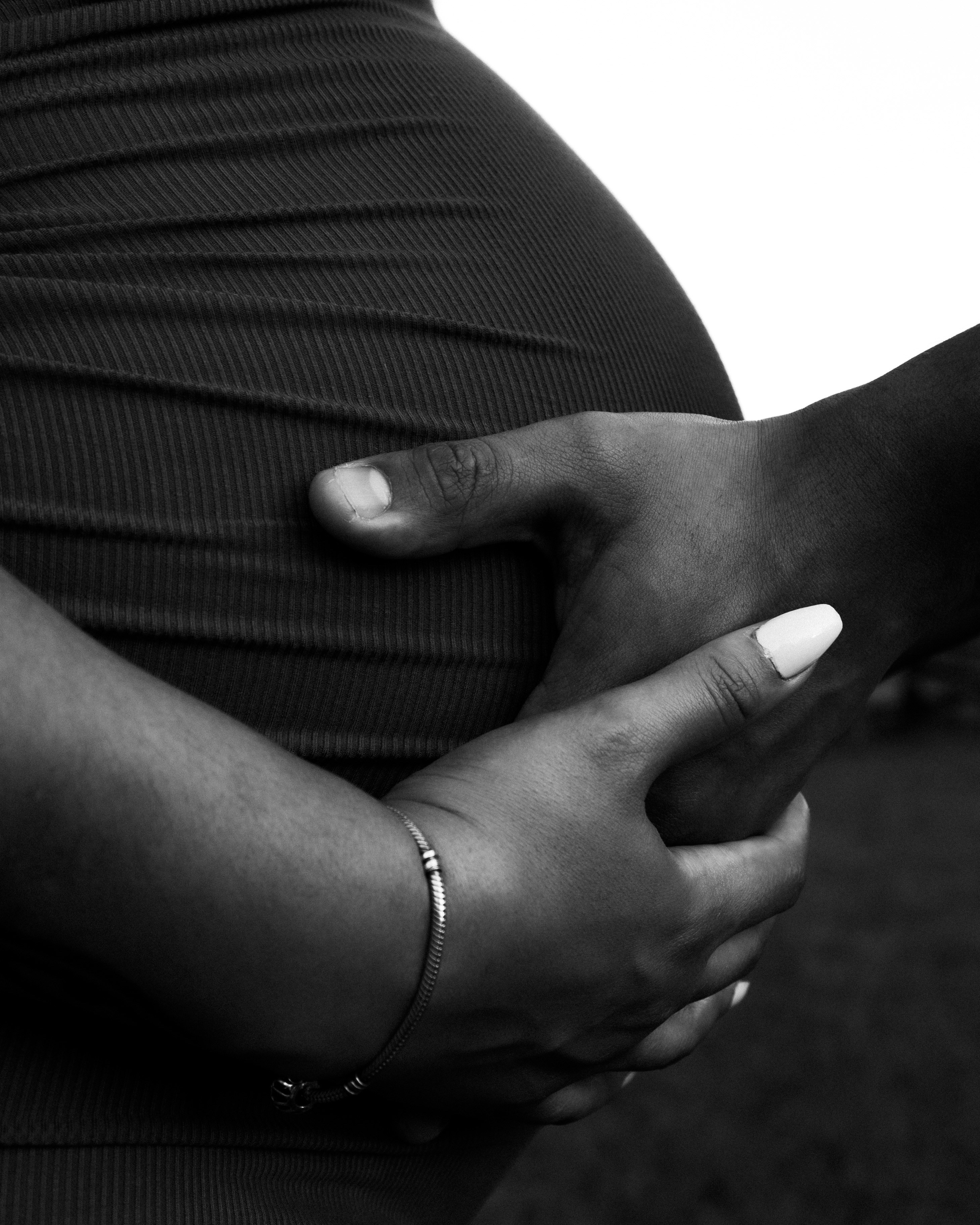 a black and white photo of a pregnant woman
