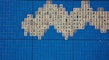 A mosaic pattern composed of Mahjong tiles is arranged on a grid of vibrant blue square tiles. The Mahjong tiles feature various traditional Chinese characters and symbols in red and black inks.