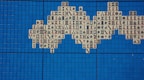 A mosaic pattern composed of Mahjong tiles is arranged on a grid of vibrant blue square tiles. The Mahjong tiles feature various traditional Chinese characters and symbols in red and black inks.