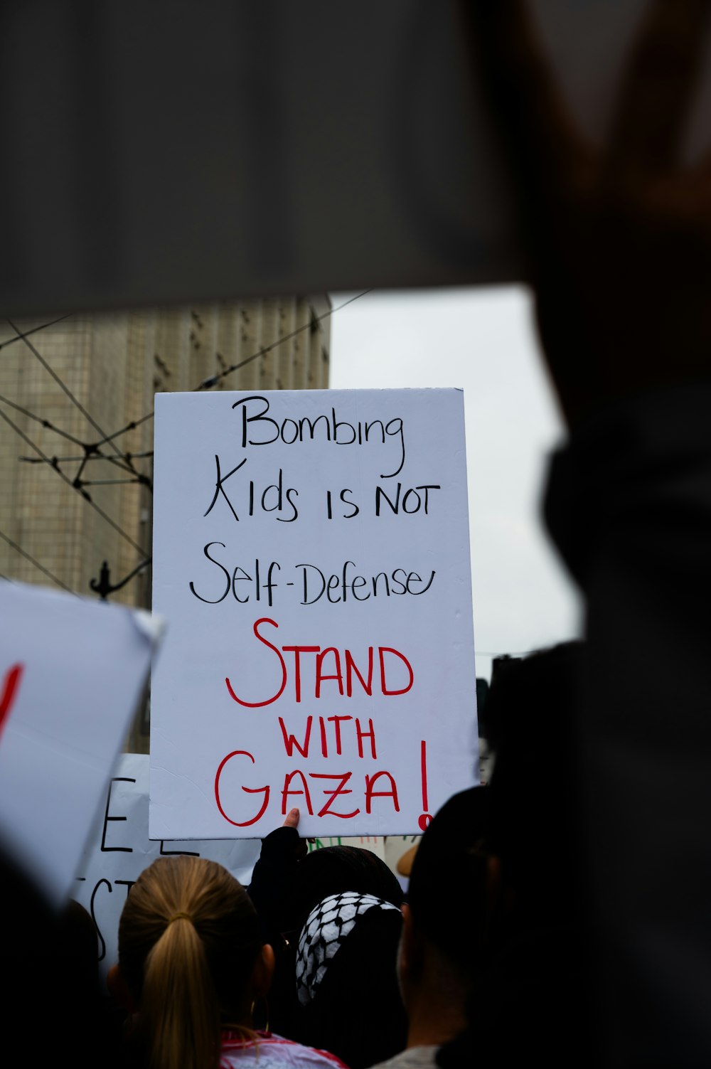 a group of people holding signs in the street