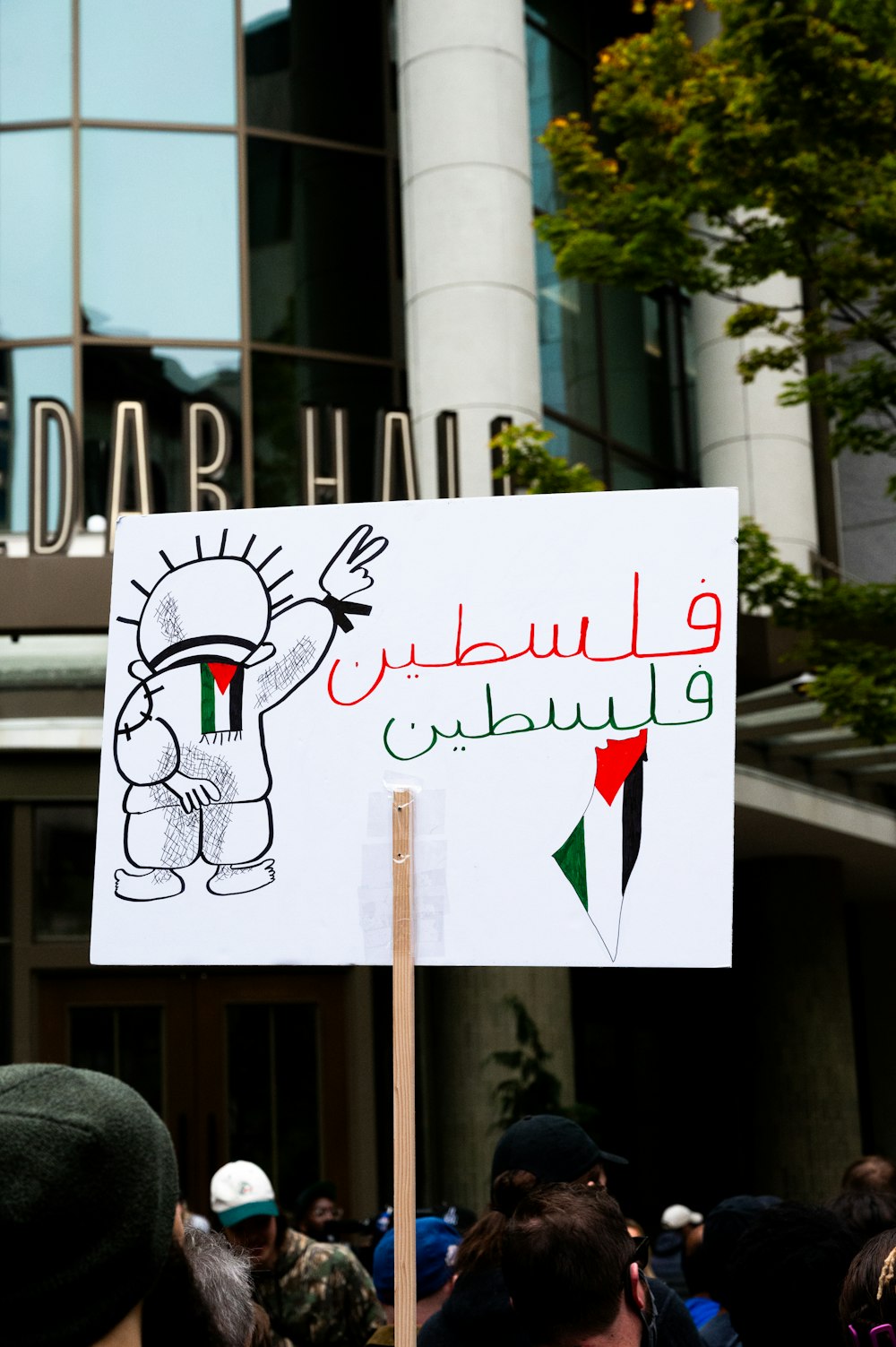 a protest sign in front of a building