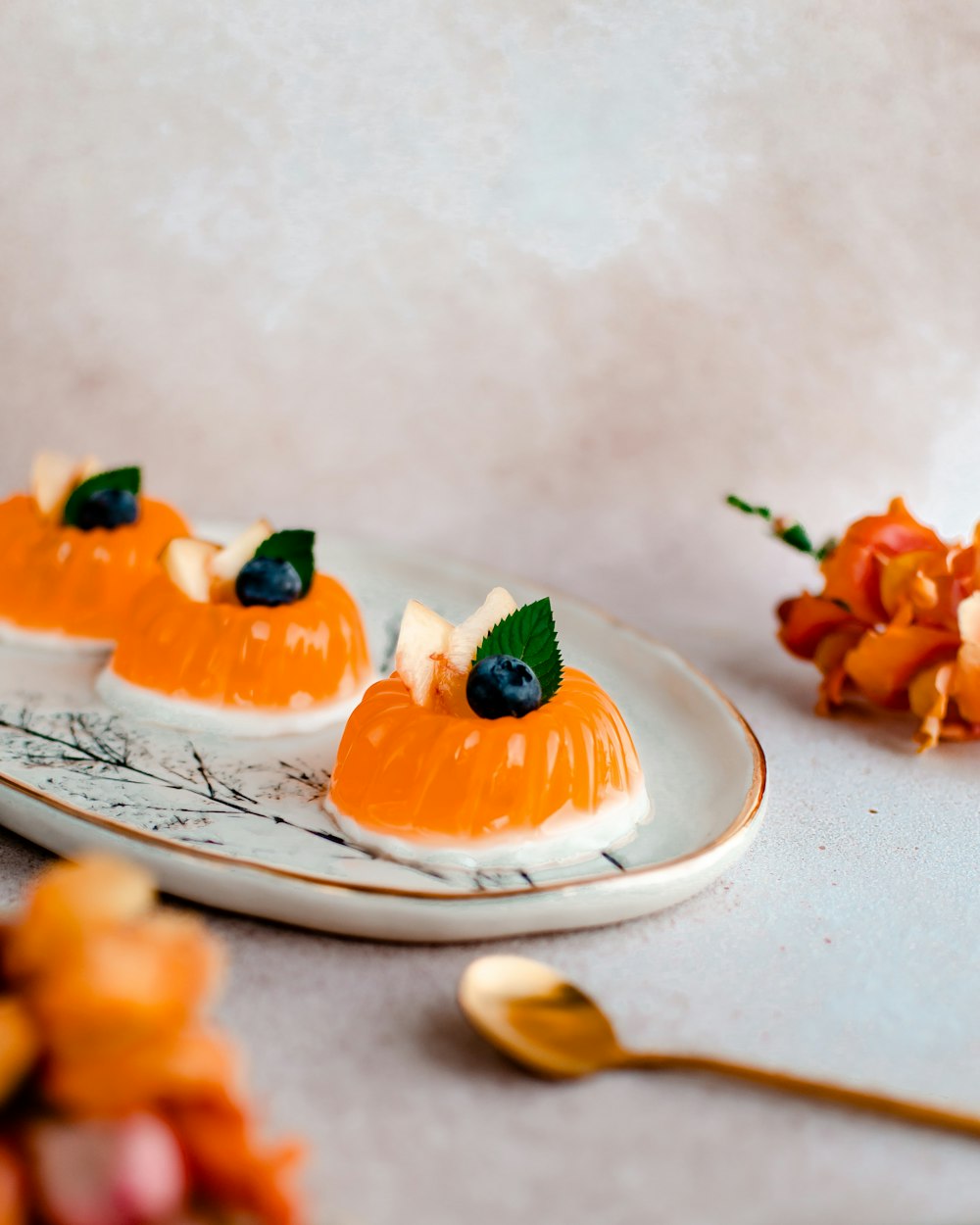 a white plate topped with three small desserts