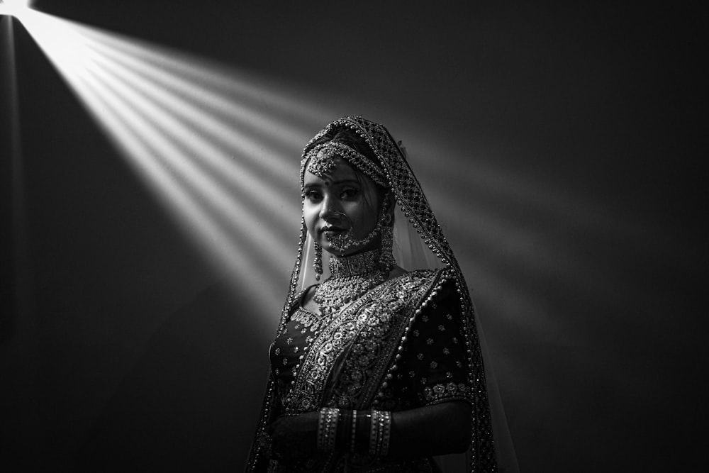 a woman standing in front of a spotlight