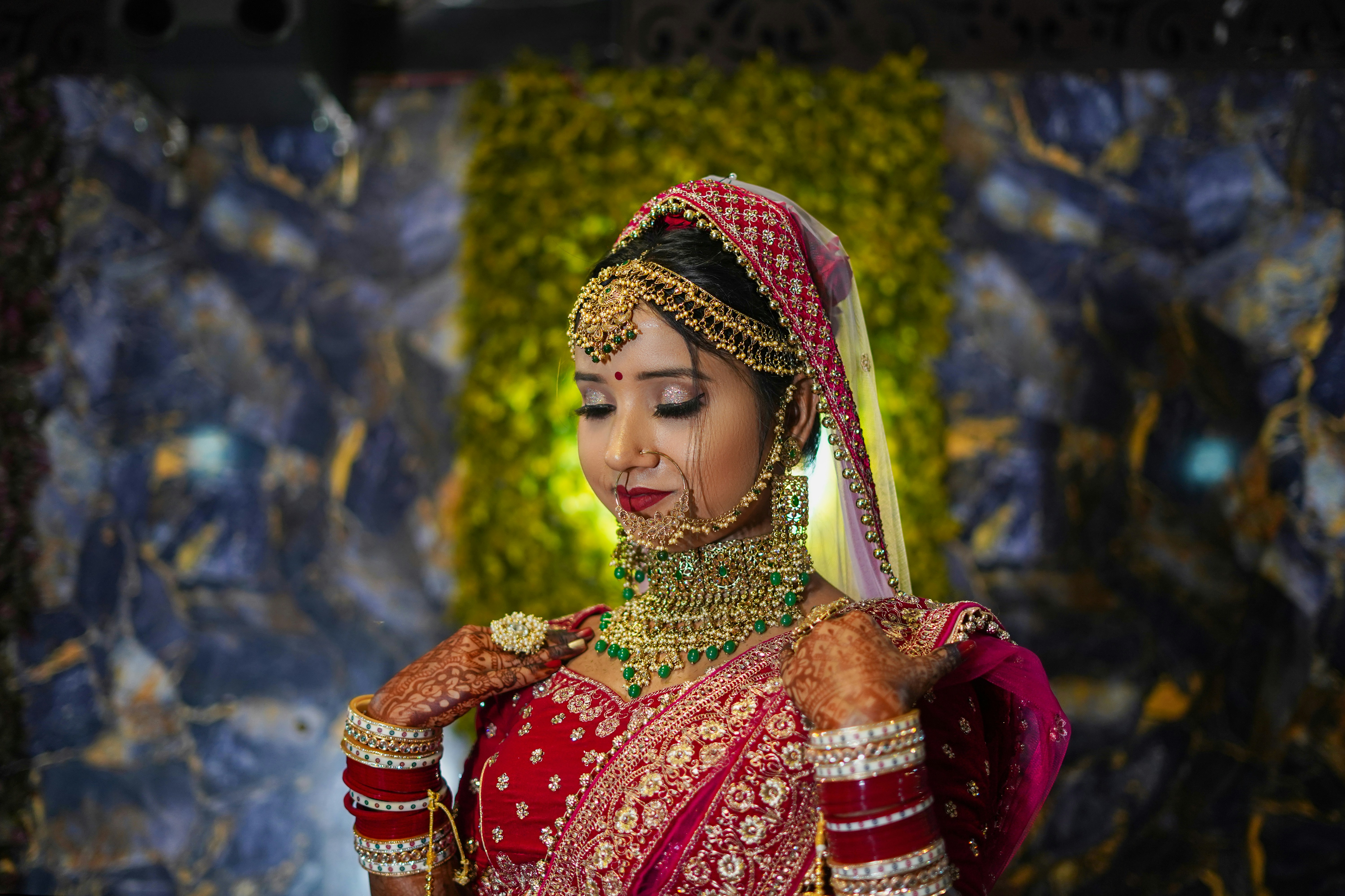 Indian bride wearing jewelry and red dress lehenga