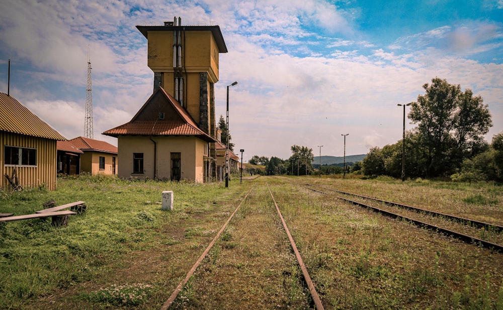 a train track with a building in the background