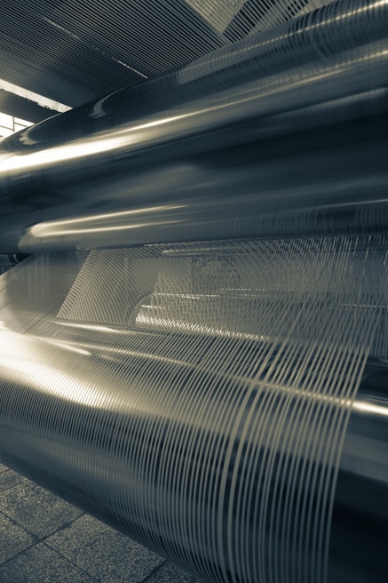 Wide shot of wire and cable machinery lined up in the manufacturing unit, showcasing their robust build