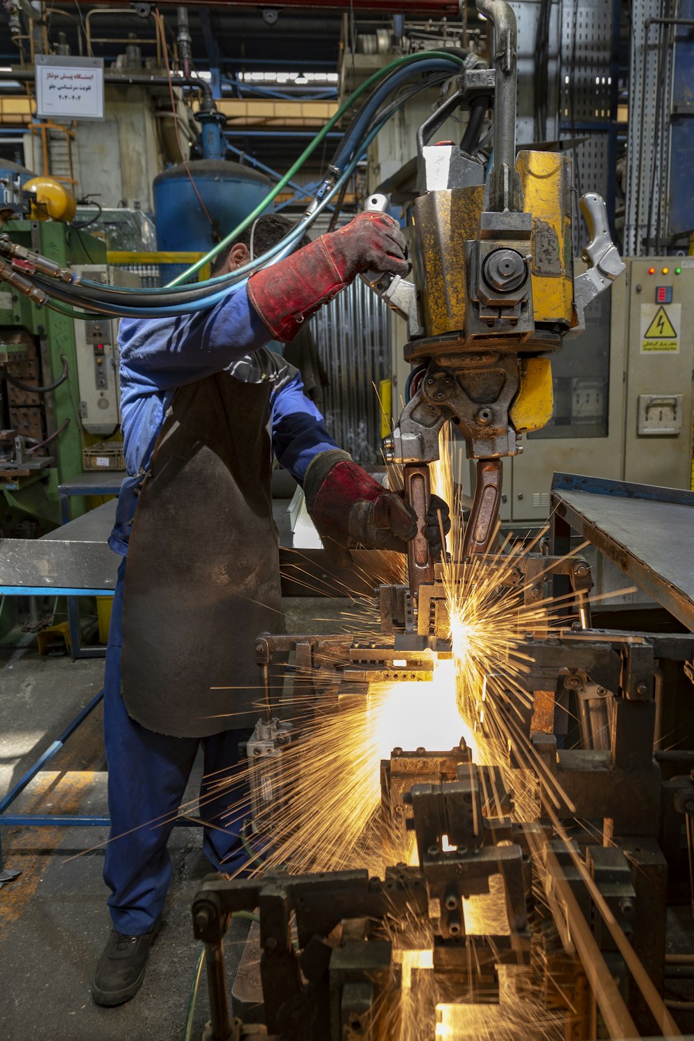 a man working on a machine in a factory