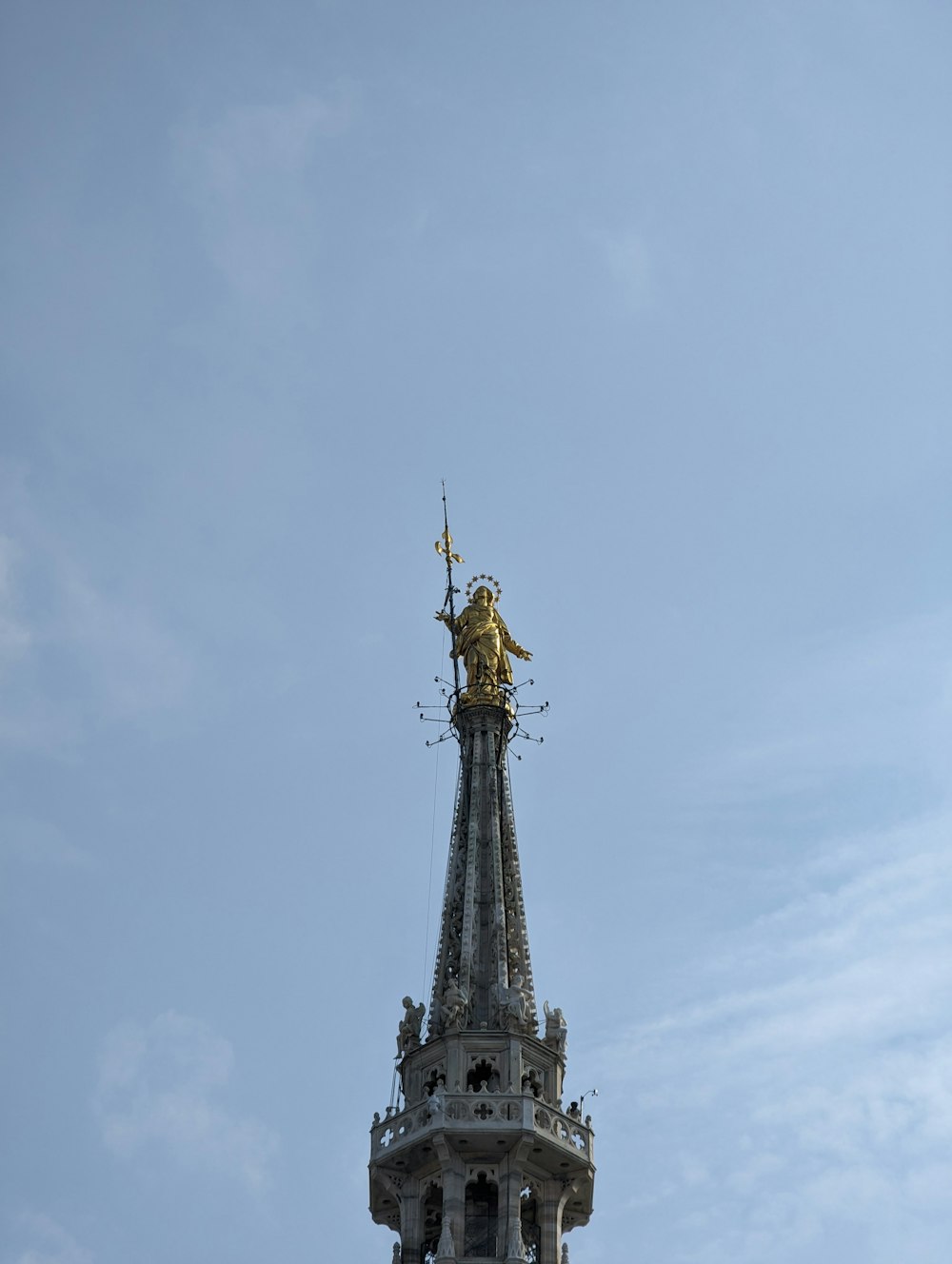 una torre dell'orologio con una statua in cima