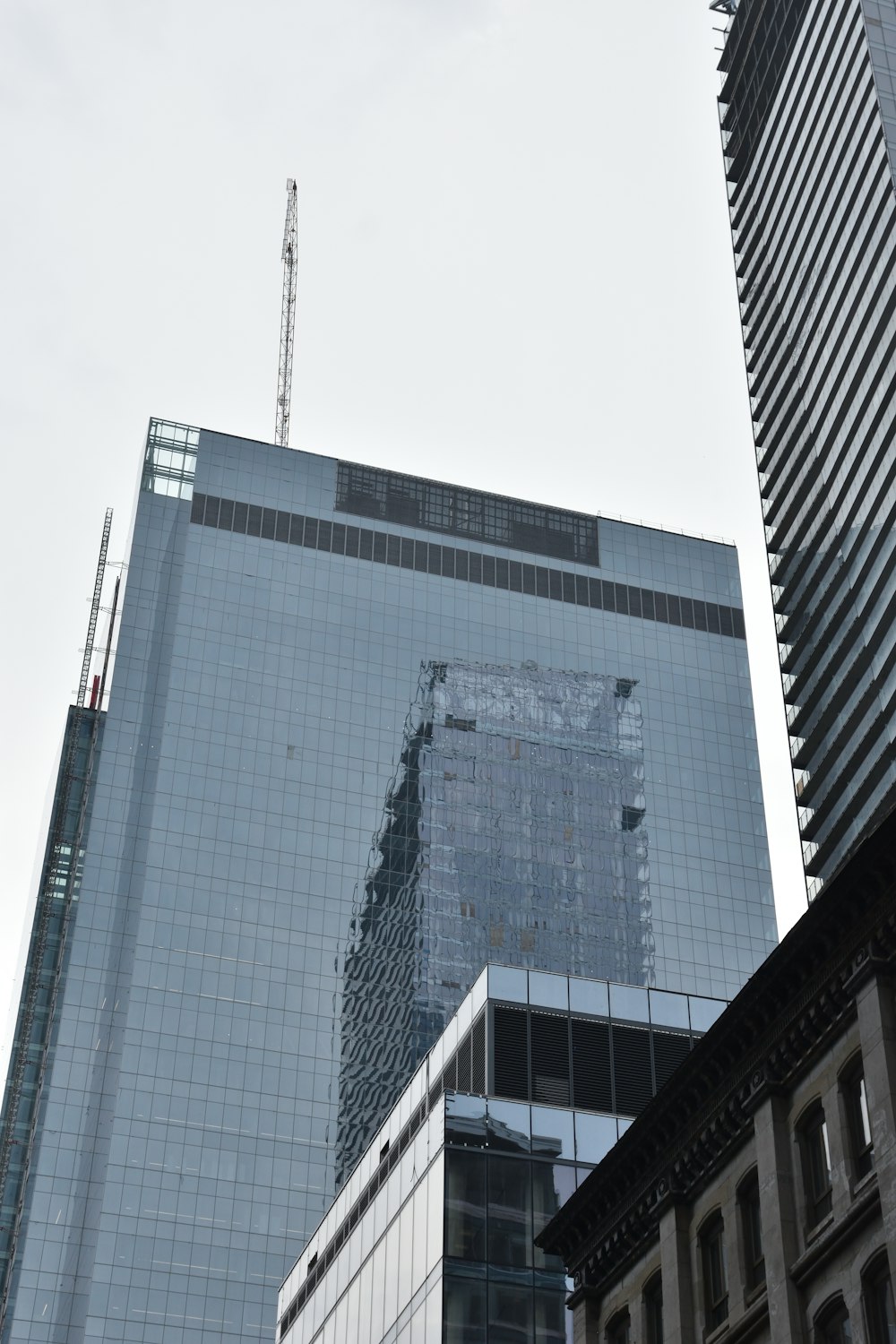 a very tall building with a crane on top of it