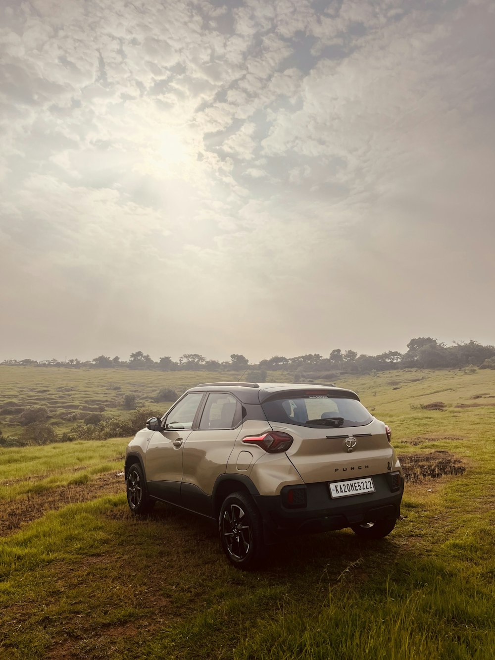 a car parked on the side of a grassy hill