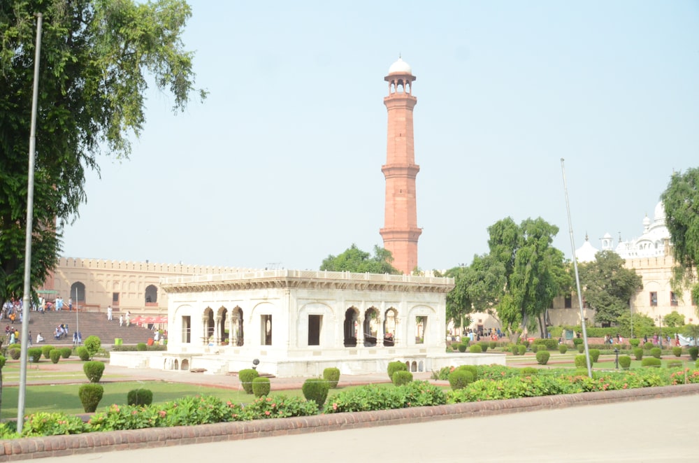 a building with a tower in the middle of a park