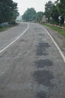 A scenic view of a rural road with unexpected obstacles.