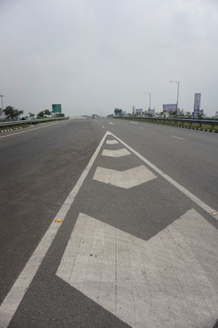 Aerial view of a highway with clear, long-lasting road markings stretching into the distance.