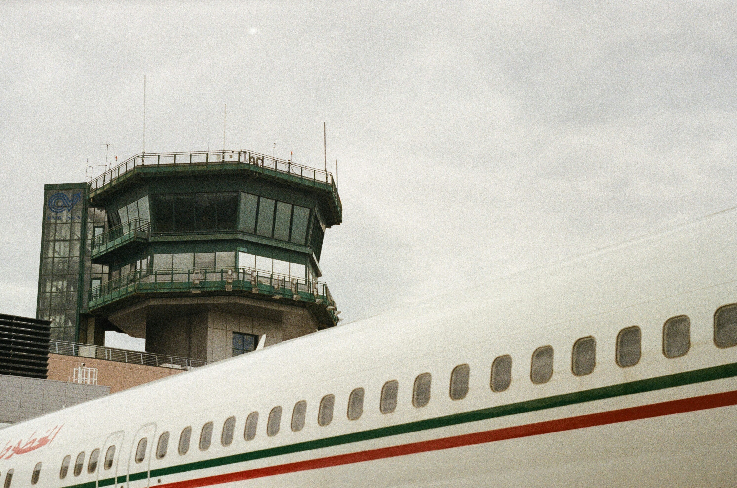 a large jetliner sitting on top of an airport tarmac, 