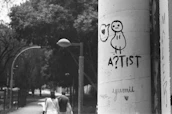 A minimalist black and white photo capturing a lively street art mural with bold graphics.