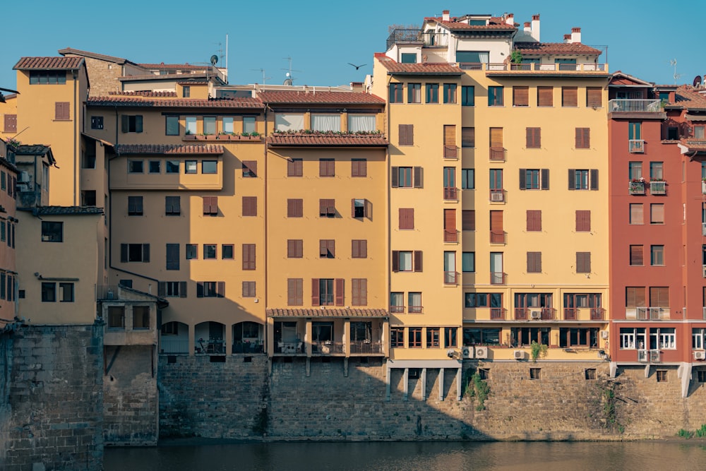 a group of buildings next to a body of water