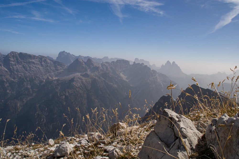 a view of a mountain range from the top of a hill