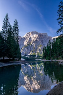 a mountain is reflected in the still water of a lake