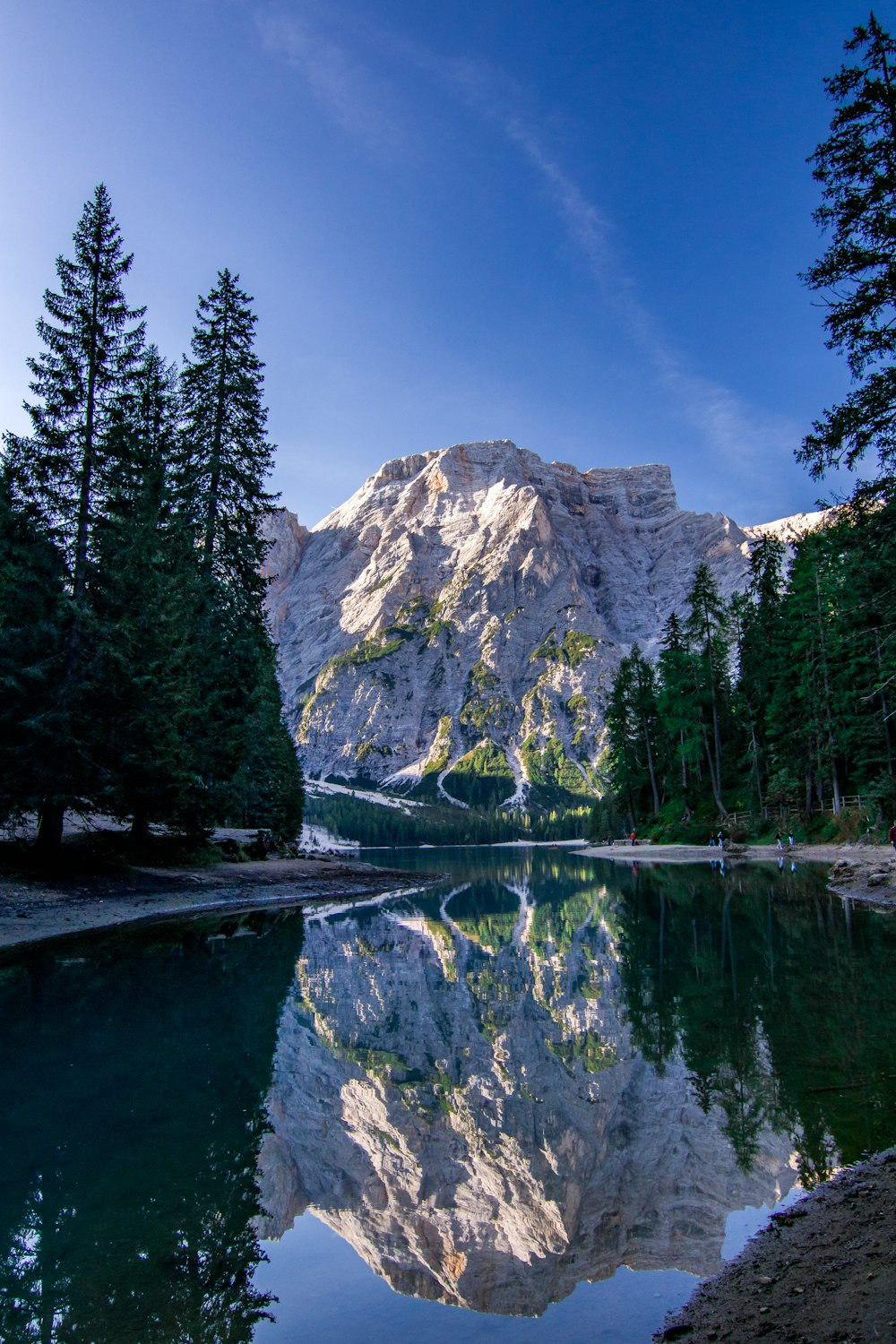 a mountain is reflected in the still water of a lake